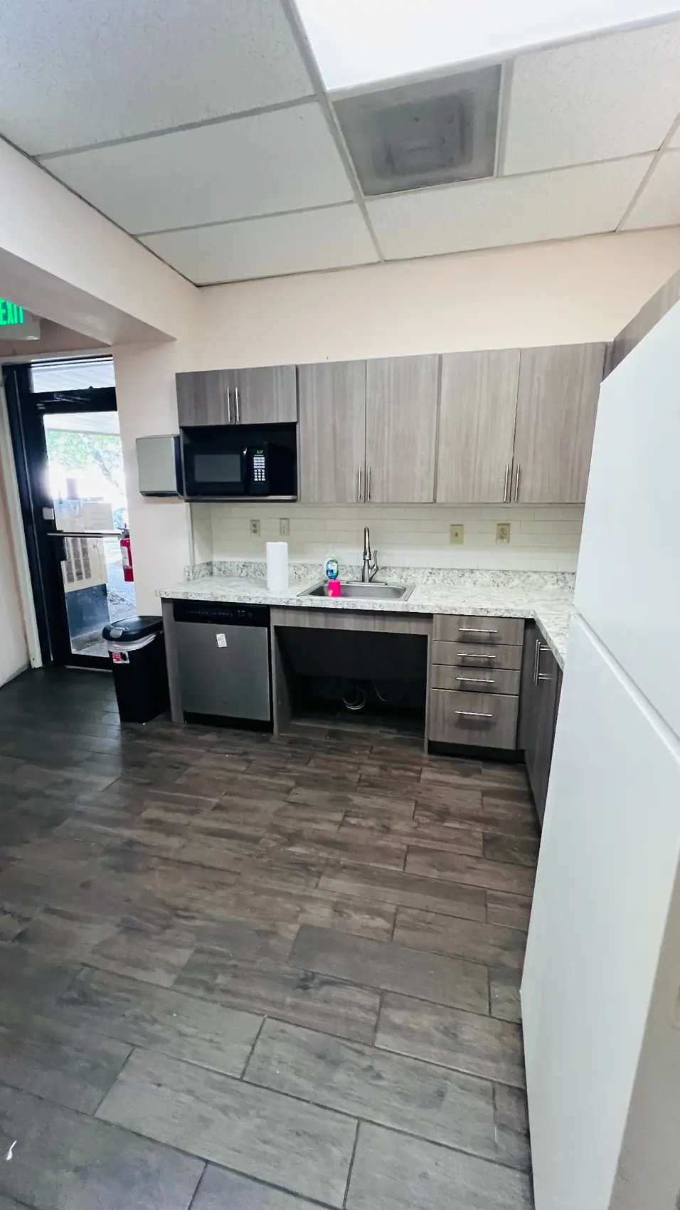 EMP Country Club guest kitchen with microwave, refrigerator, dishwasher, and sink