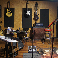 EMP Fort Worth rehearsal studio with instruments hung on wall.