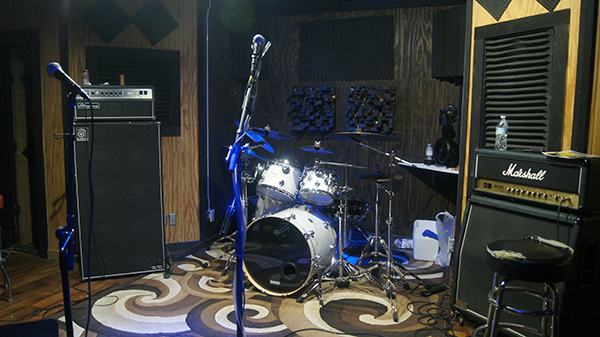 Photo of a Manley vocal mic with pop screen front and center in the cutting room of EMP Studio A.