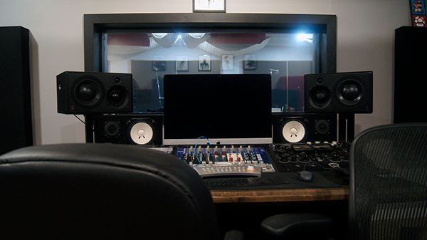 Photo of a Manley vocal mic with pop screen front and center in the cutting room of EMP Studio A.