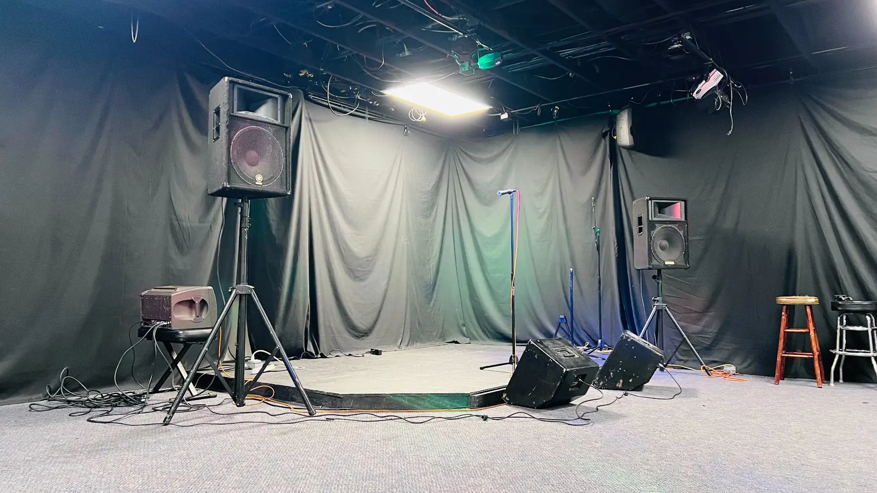 Front view of the performance stage and sound system in EMP’s large hourly room