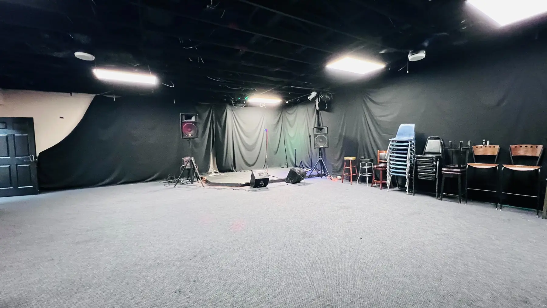 Wide view across EMP’s large hourly room toward its performance stage