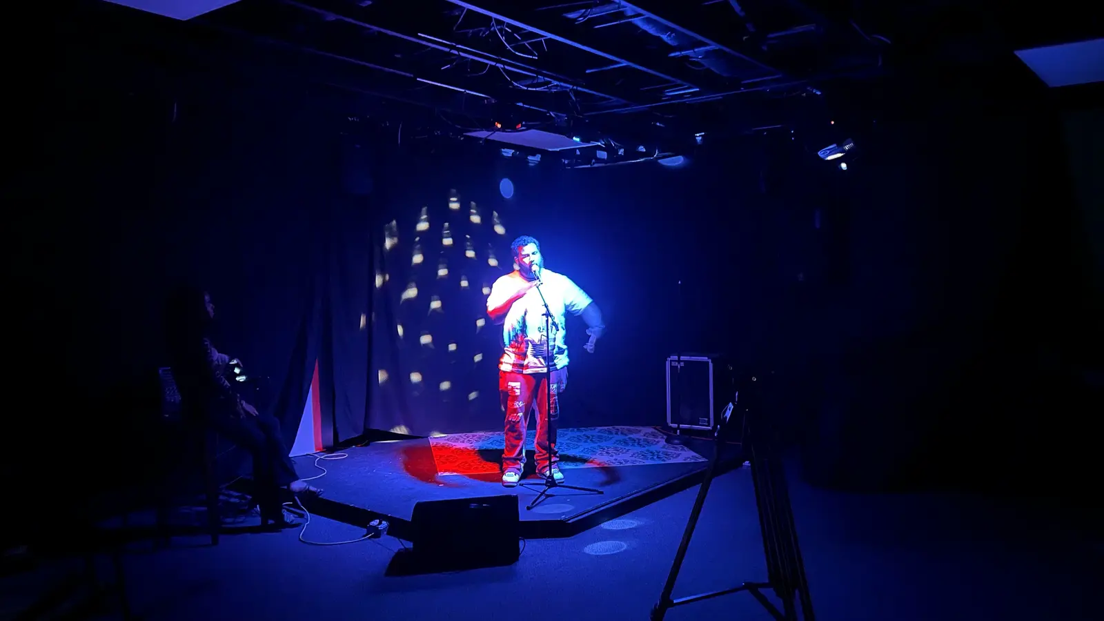 Artist performing under stage lighting in EMP’s Showcase Room