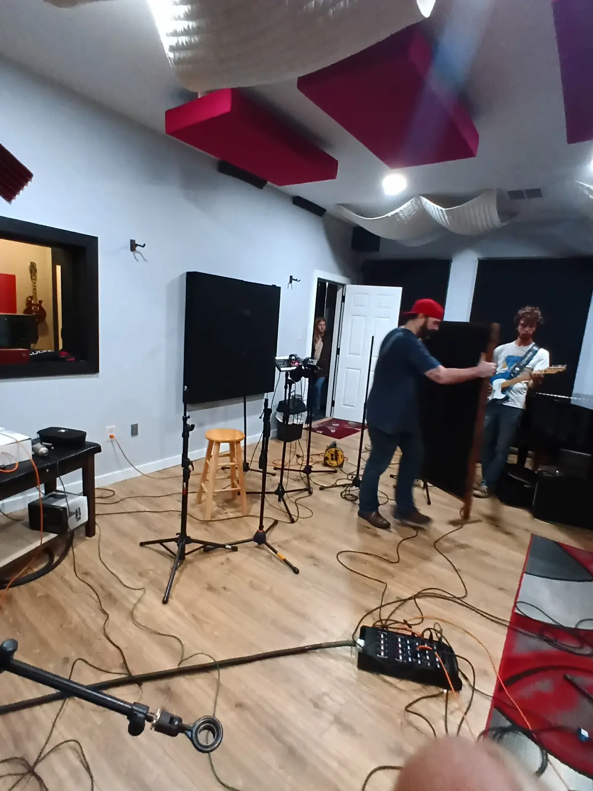 Engineer positioning acoustic gobos during a Studio A session setup